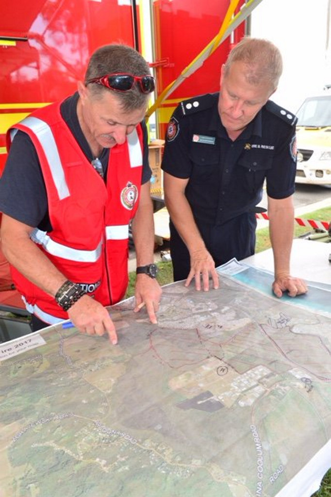 Firefighters consult the map of the fire ground. Firefighters consult the map of the fire ground.