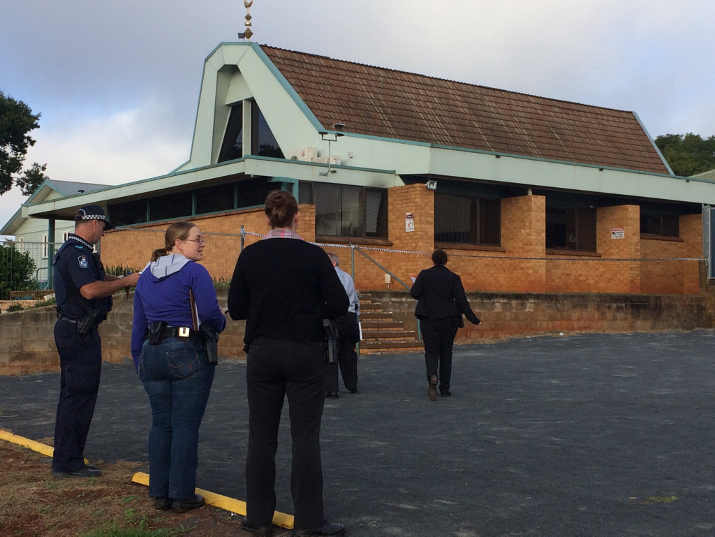 Police investigators at the scene of the Garden City Mosque fire. 