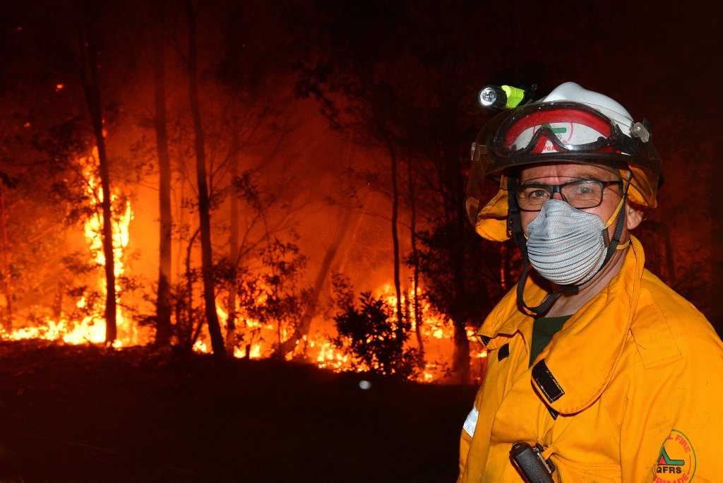 CONCERN BUT NO PANIC: A huge bushfire impacts Peregian Springs and Coolum residents as the flames threaten their homes. The fire burnt over 500 hectares and dozens of emergency crews were deployed throughout the night. Firemen battle the heat and the bleze. CONCERN BUT NO PANIC: A huge bushfire impacts Peregian Springs and Coolum residents as the flames threaten their homes. The fire burnt over 500 hectares and dozens of emergency crews were deployed throughout the night. Firemen battle the heat and the bleze.