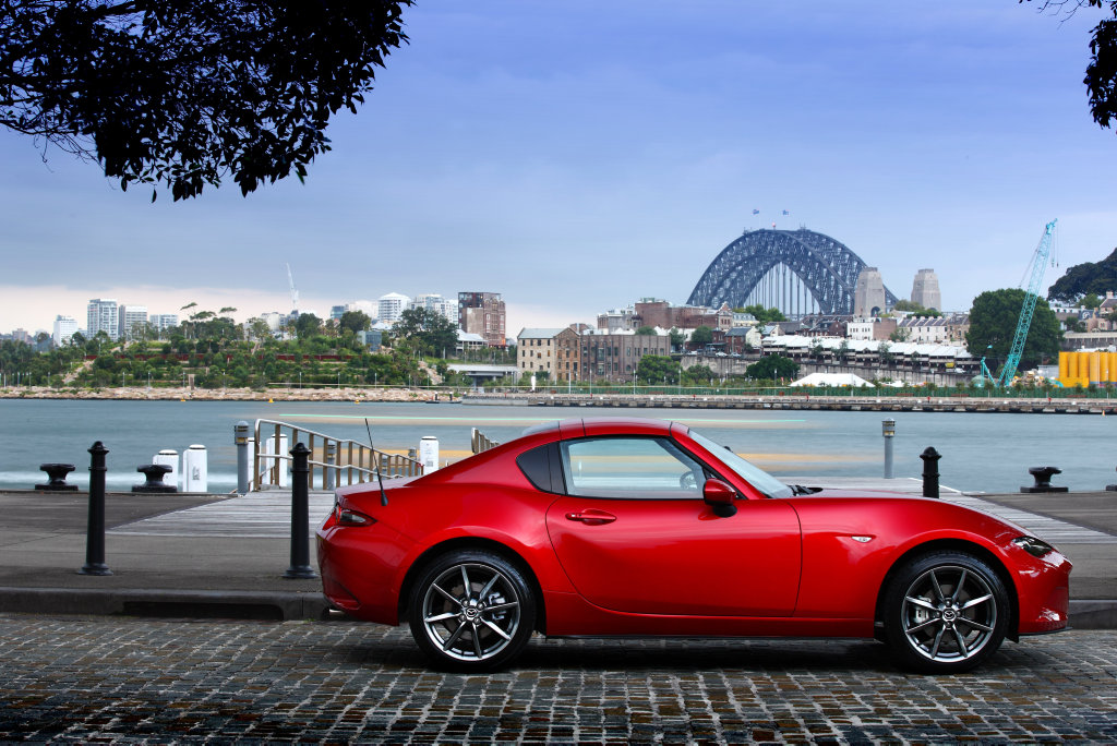 The Mazda MX-5 RF has an electrically operated hard-top retractable roof, adding broader appeal to those seeking open-top small sports car motoring. It starts from $38,550 before on-roads. The Mazda MX-5 RF has an electrically operated hard-top retractable roof, adding broader appeal to those seeking open-top small sports car motoring. It starts from $38,550 before on-roads.