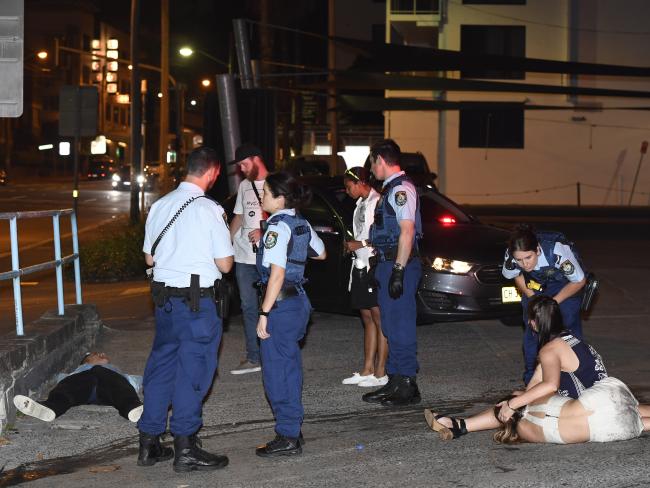 A man and a woman lie semiconscious in a Rushcutters Bay petrol station at 3am yesterday. A man and a woman lie semiconscious in a Rushcutters Bay petrol station at 3am yesterday.